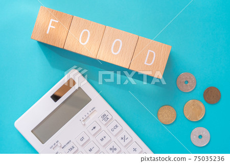 Food expenses | Building blocks, coins and calculators with "FOOD" written on them 75035236
