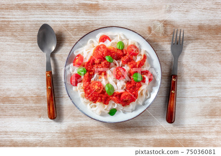 Konjac pasta with tomato sauce and basil, shot from the top Konjac pasta with tomato sauce and basil, shot from the top 75036081