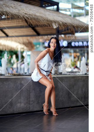 Young beautiful asian woman sitting at the table in cafe 75036488