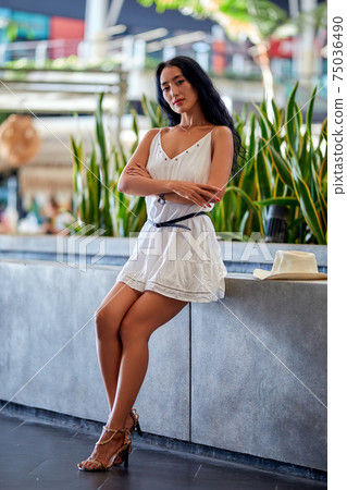 Young beautiful asian woman sitting at the table in cafe 75036490
