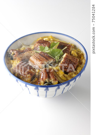 A hot eel bowl with eel kabayaki bound with eggs on a white background A hot eel bowl with eel kabayaki bound with eggs on a white background 75041284