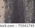 Grey texture of old broken asphalt road or wall big abrasions cracks holes on the surface pebbles cement in Sofia, Bulgaria, Eastern Europe 75041749