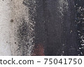 Grey texture of old broken asphalt road or wall big abrasions cracks holes on the surface pebbles cement in Sofia, Bulgaria, Eastern Europe 75041750