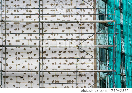 Tall building with scaffolds 75042885