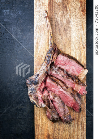Traditional barbecue dry aged wagyu tomahawk beef steak sliced 75043200