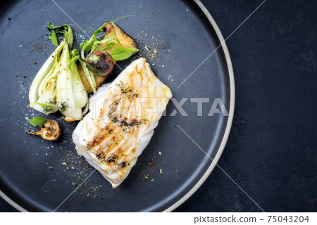 Thai fried skrei cod fish filet with bok choi and mushrooms  75043204