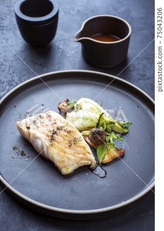 Modern style Thai fried skrei cod fish filet with bok choi and mushrooms Modern style Thai fried skrei cod fish filet with bok choi and mushrooms 75043206