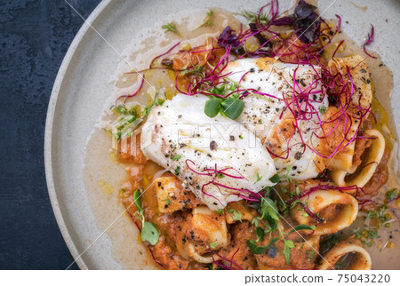 Braised codfish filet, lettuce and herbs with calamarata noodles 75043220