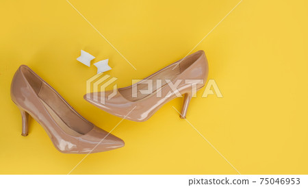 Foot silicone toe separator and beige shoes. Valgus on female feet Foot silicone toe separator and beige shoes. Valgus on female feet 75046953