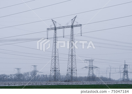 Power transmission lines. Winter landscape with high voltage power lines. 75047184
