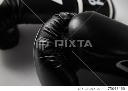 Pair of black boxing gloves on white background, closeup Pair of black boxing gloves on white background, closeup 75048460