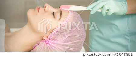 Hand applying alginate mask on face Hand applying alginate mask on face 75048891