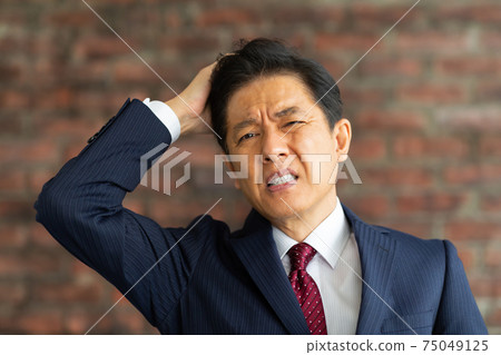 與困惑的神色的一個商人 75049125