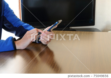 Operate your smartphone with your finger on the table Operate your smartphone with your finger on the table 75049656