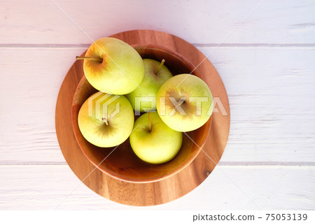 top view of fresh green apple on wooden background top view of fresh green apple on wooden background 75053139