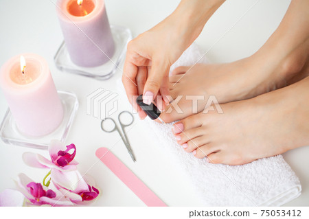 Cheerful Girl Doing Nails Making Pedicure Sitting In Bed Indoor. Cheerful Girl Doing Nails Making Pedicure Sitting In Bed Indoor. 75053412