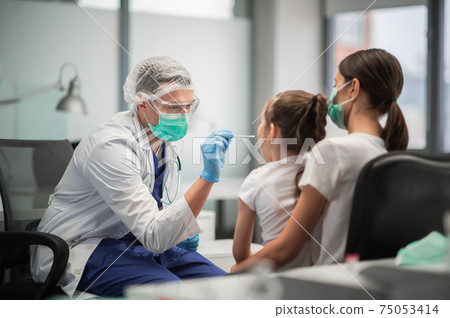 Mom brought her little daughter to the clinic to be tested for coronavirus, the doctor takes a smear Mom brought her little daughter to the clinic to be tested for coronavirus, the doctor takes a smear 75053414