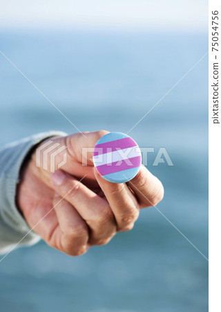 showing a transgender pride flag in a pin button 75054756