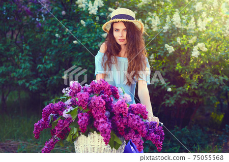 Portrait of a happy beautiful young girl with vintage bicycle and flowers on city background in the sunlight outdoor Portrait of a happy beautiful young girl with vintage bicycle and flowers on city background in the sunlight outdoor 75055568