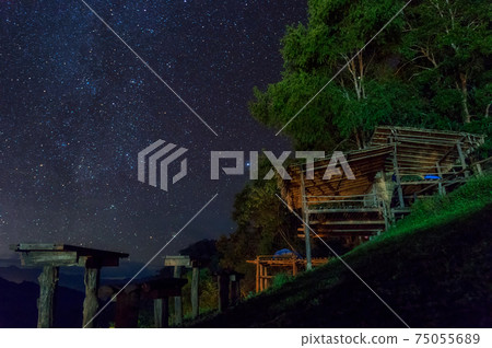 Huts and stars at night. 75055689