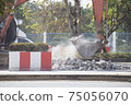 Excavator digging   a road. Construction concept. 75056070