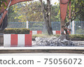 Excavator digging   a road. Construction concept. 75056072