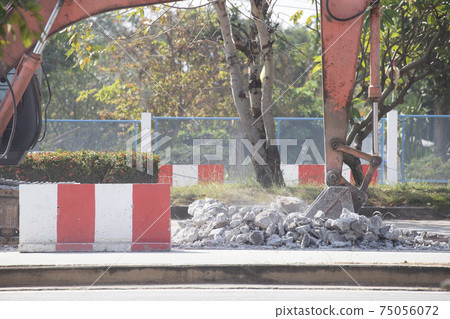 Excavator digging   a road. Construction concept. 75056072