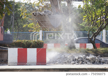 Excavator digging a road. Construction concept. Excavator digging a road. Construction concept. 75056073