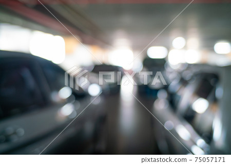 Blurred car parking row indoor supermarket Blurred car parking row indoor supermarket 75057171