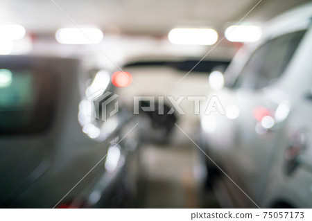 Blurred car parking row indoor supermarket Blurred car parking row indoor supermarket 75057173