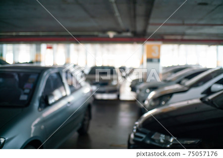 Blurred car parking row indoor supermarket Blurred car parking row indoor supermarket 75057176