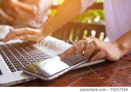 Hand on laptop. 75057384
