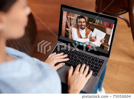 Woman using laptop having video chat with teacher Woman using laptop having video chat with teacher 75058004