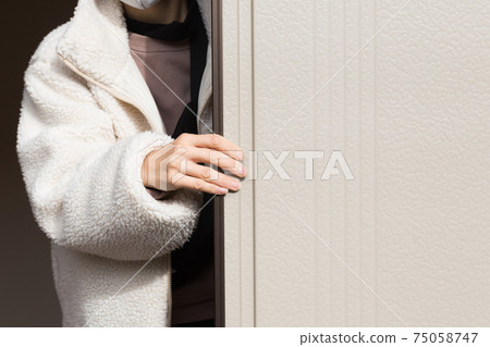 Woman closing the shutter 75058747