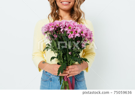 Close-up happy smiling young woman holding bouquet of fresh pink flowers Close-up happy smiling young woman holding bouquet of fresh pink flowers 75059636
