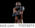 Football Player with a orange uniform coming out of a stadium tunnel. 75059874