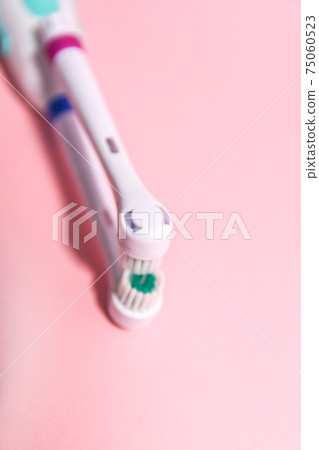 Electrical toothbrushes on a soft light background 75060523