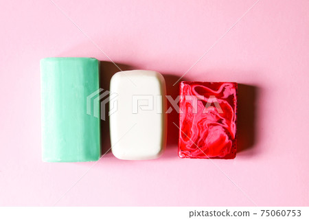 Different coloful soap on soft pink background 75060753