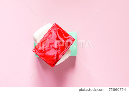 Different coloful soap on soft pink background 75060754
