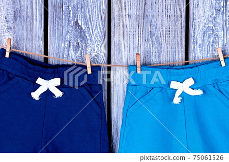 Kids pants hanging on rope. 75061526