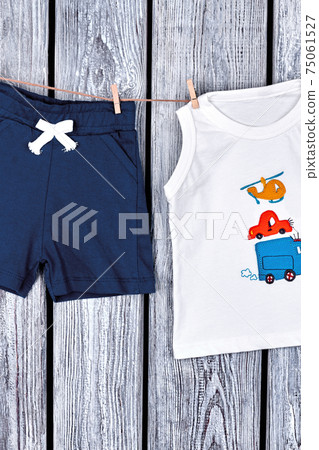 Baby boy apparel hanging on rope. Baby boy apparel hanging on rope. 75061527