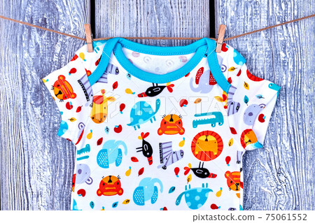 Infant baby t-shirt hanging on rope. Infant baby t-shirt hanging on rope. 75061552