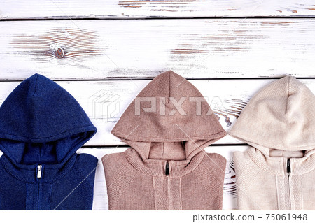 Hooded knitted pullovers, copy space. Hooded knitted pullovers, copy space. 75061948