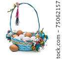 Easter basket with eggs and flower arrangement on a white background 75062157