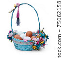Easter basket with eggs and flower arrangement on a white background 75062158