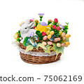 Easter basket from a flower arrangement and a hare on white background 75062169