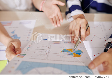 Financial experts analyzing report Financial experts analyzing report 75062737