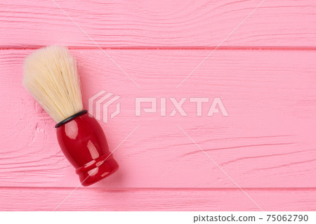 Shaving brush on a wooden background. 75062790
