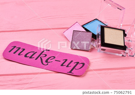 Multicolored eyeshadows on pink background. 75062791