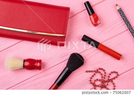 Makeup cosmetics and red purse. 75062807
